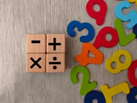 The image displays wooden cubes with basic mathematical operation symbols Stock Photos