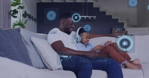 Image of diverse data over happy african american father and son using tablet イラスト素材