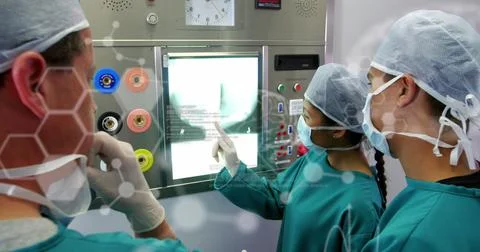 Image of diverse doctors with xray over data processing Stock Photos