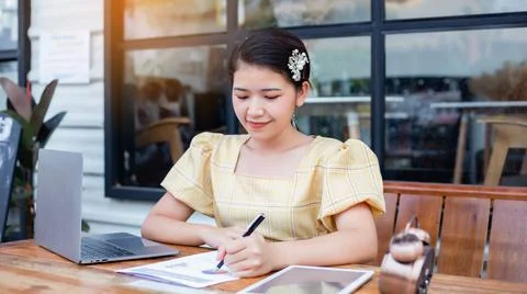 Image of document with charts on background of male and female working , busi Stock Photos