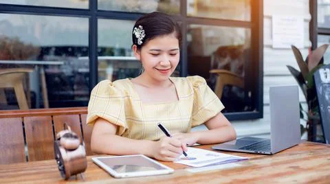 Image of document with charts on background of male and female working , busi Stock Photos