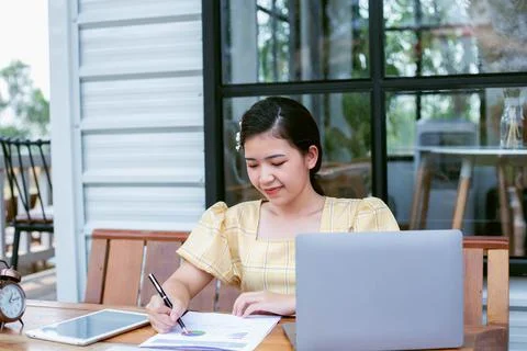 Image of document with charts on background of male and female working , busi Foto stock