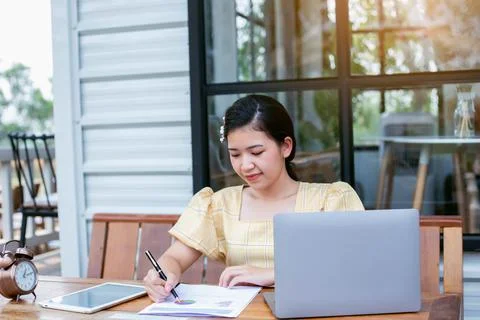 Image of document with charts on background of male and female working , busi Stock Photos