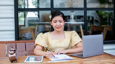 Image of document with charts on background of male and female working , busi Stock Photos