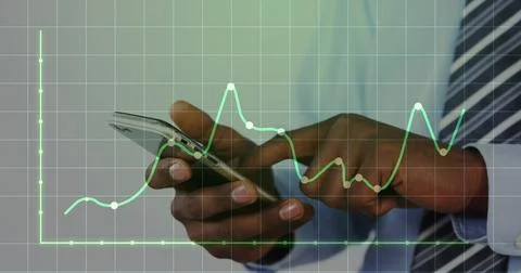 Image of dots on graph and grid pattern over african american businessman using Stock Photos