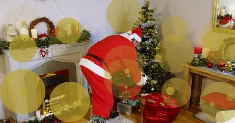 Image of dots moving over santa claus leaving presents under christmas tree Stock Illustration
