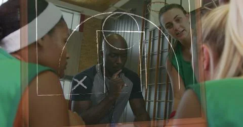 Image of drawing of game plan over diverse coach and female basketball players 스톡 사진