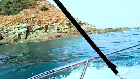 This image is a dynamic view from the front of a moving boat, slicing through cl Stock Footage 320168421