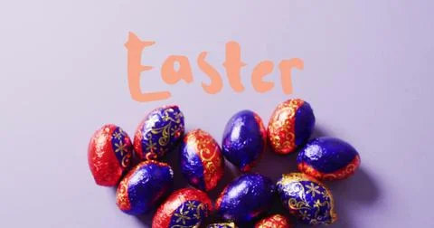 Image of easter text over colourful easter eggs on purple background Stock Photos