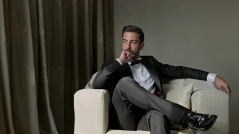 Image Of An Elegant Young Man In Suit. He Is Sitting On The Couch. His Hand Stock Footage 153701289