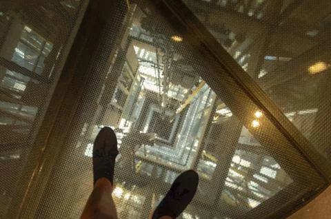 Image of an elevator shaft seen from above on safety glass Stock Photos