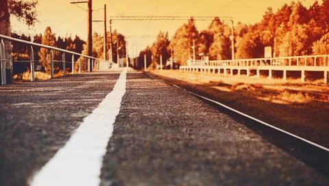 An image of an empty old railway platform on an autumn evening with an orange Stock Photos