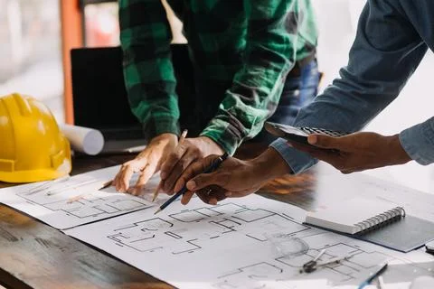Image of engineering objects on workplace with three partners interacting o.. Stock Photos