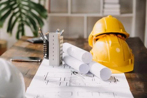 Image of engineering objects on workplace with three partners interacting o.. Foto stock