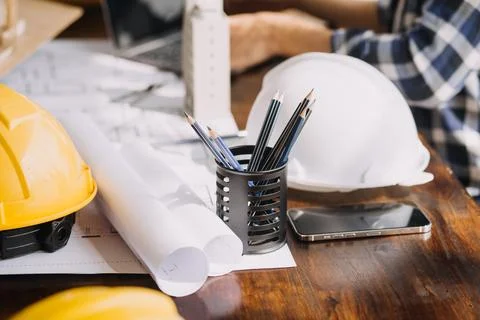Image of engineering objects on workplace with three partners interacting o.. Foto stock
