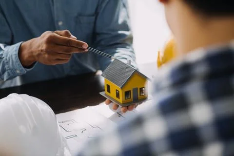 Image of engineering objects on workplace with three partners interacting o.. Stock Photos
