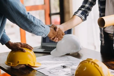 Image of engineering objects on workplace with three partners interacting o.. Stock Photos