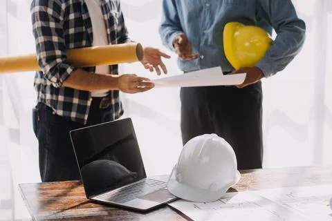 Image of engineering objects on workplace with three partners interacting o.. Stock Photos
