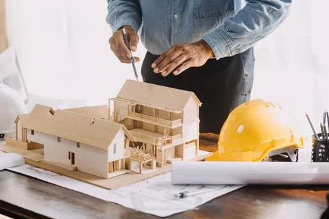 Image of engineering objects on workplace with three partners interacting o.. Stock Photos