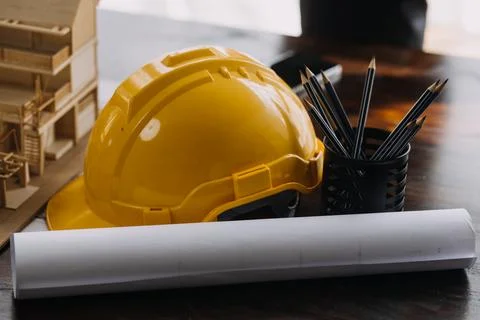 Image of engineering objects on workplace with three partners interacting o.. Stock Photos