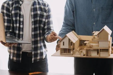Image of engineering objects on workplace with three partners interacting o.. Stock Photos