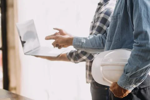 Image of engineering objects on workplace with three partners interacting o.. Stock Photos