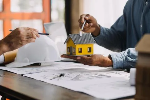 Image of engineering objects on workplace with three partners interacting o.. Stock Photos