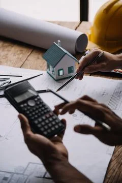 Image of engineering objects on workplace with three partners interacting o.. Stock Photos