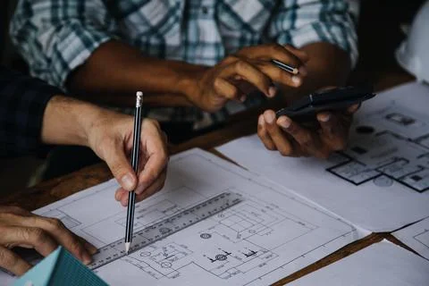 Image of engineering objects on workplace with three partners interacting o.. Stock Photos