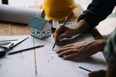 Image of engineering objects on workplace with three partners interacting o.. Stock Photos