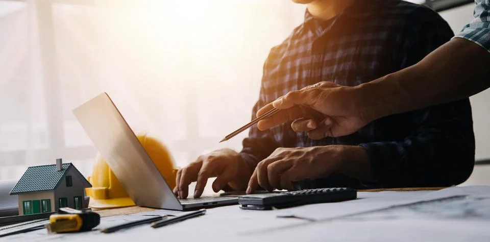Image of engineering objects on workplace with three partners interacting o.. Foto stock