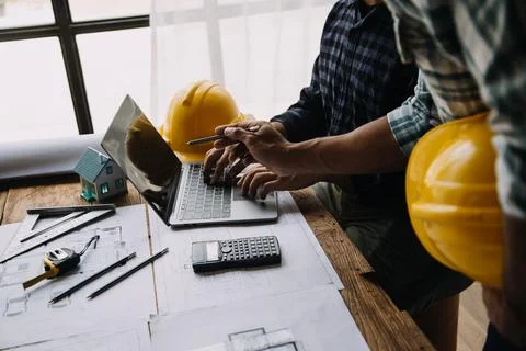 Image of engineering objects on workplace with three partners interacting o.. Stock Photos