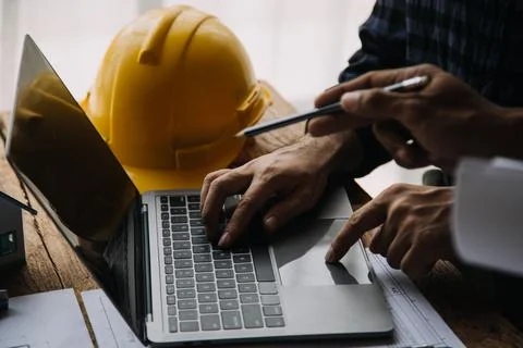 Image of engineering objects on workplace with three partners interacting o.. Foto stock