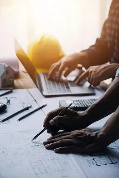 Image of engineering objects on workplace with three partners interacting o.. Stock Photos