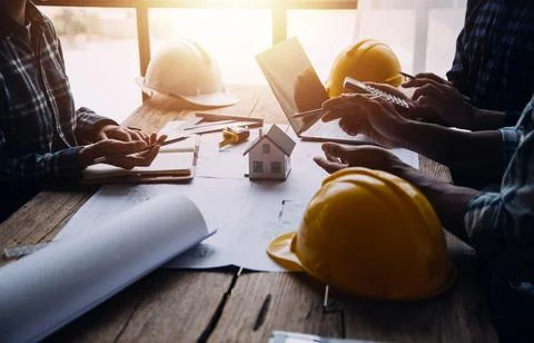 Image of engineering objects on workplace with three partners interacting o.. Stock Photos