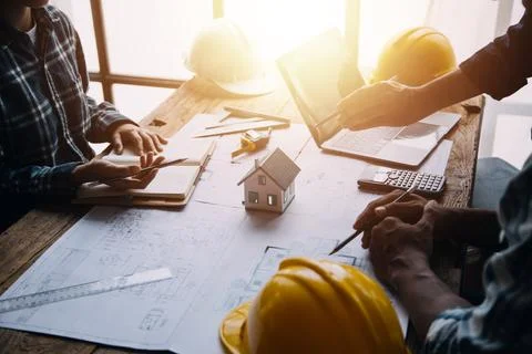 Image of engineering objects on workplace with three partners interacting o.. Stock Photos
