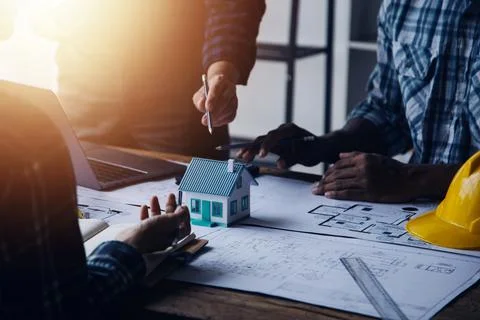 Image of engineering objects on workplace with three partners interacting o.. Stock Photos