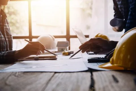 Image of engineering objects on workplace with three partners interacting o.. Stock Photos