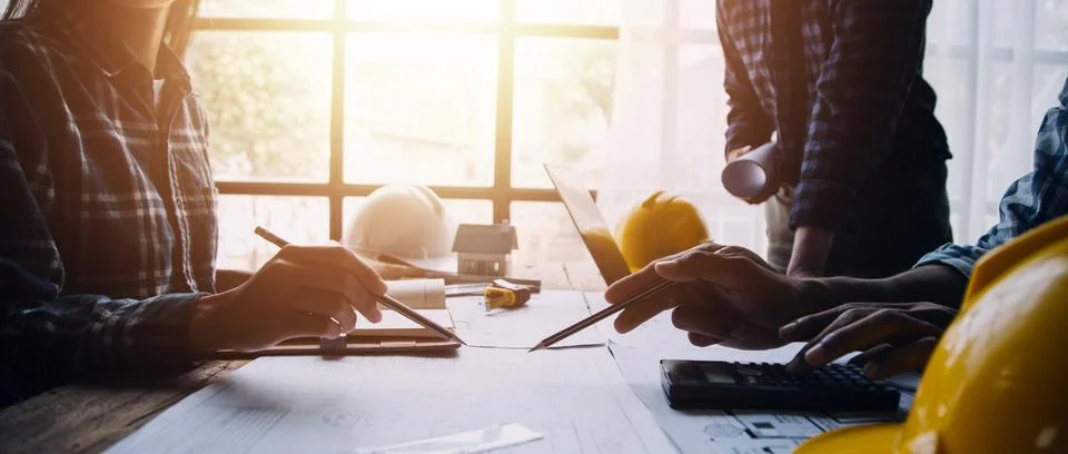 Image of engineering objects on workplace with three partners interacting o.. Stock Photos