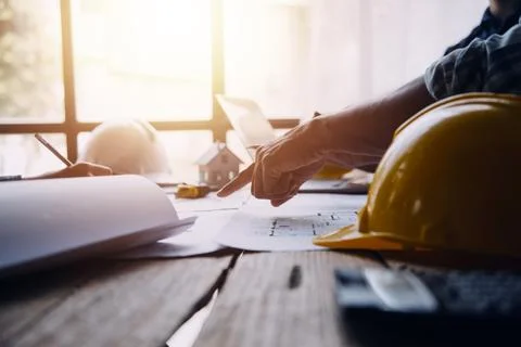 Image of engineering objects on workplace with three partners interacting o.. Stock Photos