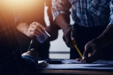 Image of engineering objects on workplace with three partners interacting o.. Stock Photos