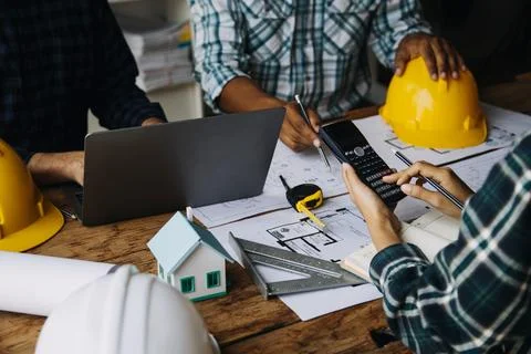 Image of engineering objects on workplace with three partners interacting o.. Stock Photos