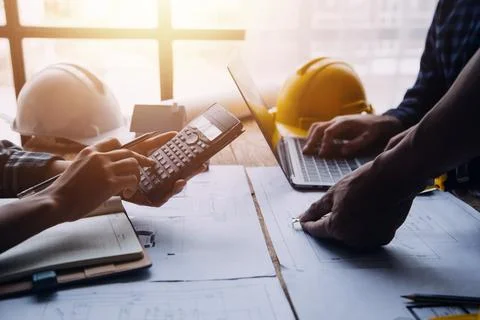 Image of engineering objects on workplace with three partners interacting o.. Stock Photos