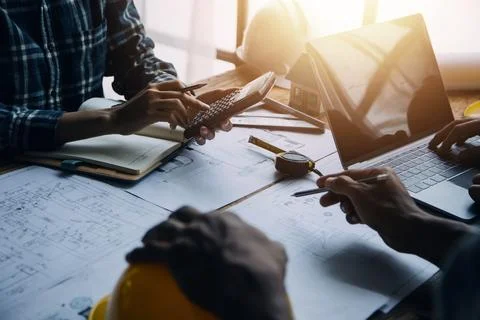 Image of engineering objects on workplace with three partners interacting o.. Stock Photos