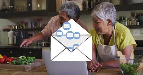 Image of envelope mail icons over senior couple using laptop at home Fotos Stock