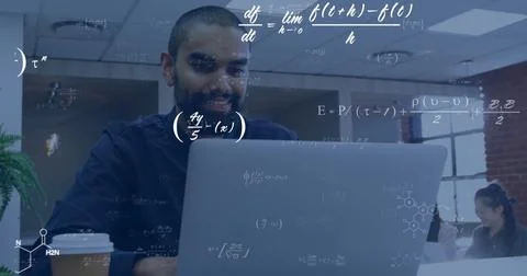 Image of equations at elements over happy biracial male student using laptop in Fotos Stock