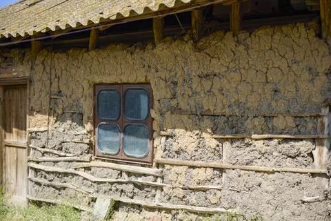 Image of the facade of an old adobe and wood house Stock Photos