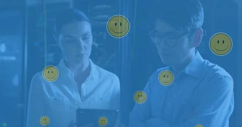 Image of falling emoji over diverse couple of server room workers Stock Illustration