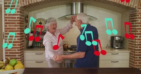 Image of falling notes over caucasian senior couple dancing Fotos Stock