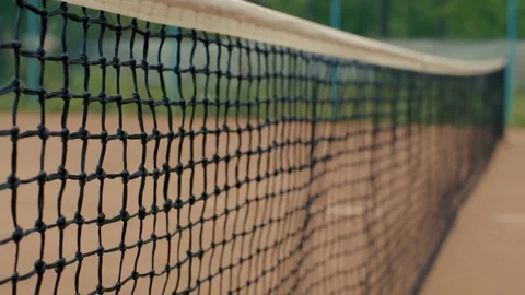 This image features a closeup view of a Tennis Net located on a Clay Court Stock Footage 285605641